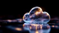 Magical glowing cloud shape with sparkles and stars reflecting on wet surface against dark background creates dreamy atmosphere and cosmic mood.