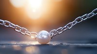 Single pearl on silver chain against blurred sunset background with soft bokeh lights creating romantic atmospheric jewelry composition.