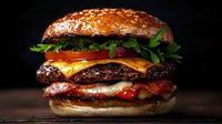 Juicy cheeseburger with melted cheese, crispy bacon, fresh lettuce, tomato and onion rings on sesame bun against dark background. For restaurant menu and food advertising.