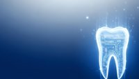 Digital tooth with circuit board pattern glowing on blue background for dental technology and healthcare innovation concepts.