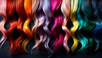 Vibrant wavy hair strands in rainbow colors from red to blue arranged in vertical pattern against dark background, showcasing diverse hair dye possibilities for salon use.