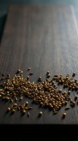 Roasted coffee beans scattered on dark wooden surface, showcasing rich brown tones and texture for beverage, culinary, and food styling projects.
