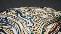 Abstract fluid art with swirling multicolored paint creating marble-like patterns on dark background for modern design projects.
