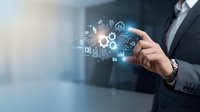 Professional businessman touching digital technology interface with glowing icons representing cloud computing, data analytics and business automation solutions.