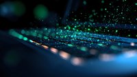 Magical green and blue glowing particles floating in dark space with bokeh light effect creating ethereal atmospheric background for creative projects.
