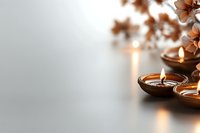 Lit candles in wooden holders with dried flowers and neutral background, suitable for wellness, spa, meditation, and home decor design projects.