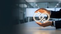 Hands holding glowing infinity symbol representing endless possibilities, sustainable growth, and continuous improvement in modern business environment.