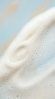 Creamy white foam swirl with delicate bubbles on soft pastel background for skincare and beauty product advertising campaigns.