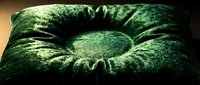 Moss-covered stone ring with textured surface and natural weathering, suitable for nature, garden, and environmental design projects.