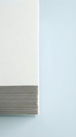 Stack of white paper sheets with clean edges on neutral background for office supplies and business documentation concepts.
