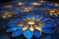 Glowing blue and gold floral pattern with metallic petals creating an illuminated mandala design against dark background, artistic macro photography.