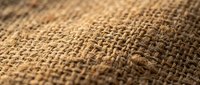 Natural burlap fabric texture with woven fibers creating rustic background for crafts, packaging, and eco-friendly design projects.
