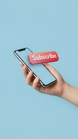 Hand holding smartphone with red subscribe button floating above blank screen on light blue background, social media concept.