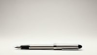 Elegant silver fountain pen with black accents lying horizontally on neutral background for business and writing concepts.