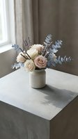 Elegant floral arrangement with cream roses, lavender and eucalyptus in ceramic vase on marble table by window for home decor and interior design.