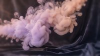 Abstract colorful smoke clouds in purple and pink hues swirling through dark space creating dynamic fluid motion for creative design projects.