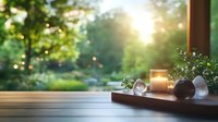 Serene wooden windowsill with glowing candle, crystals and small plants against blurred garden background with sunset and bokeh lights creating peaceful atmosphere.