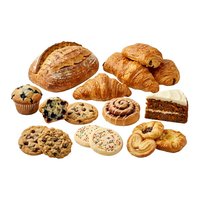Assorted fresh baked goods including croissants, bread, cookies, muffin and cake slice isolated on white background for bakery, cafe and food design projects.