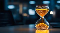 Glowing hourglass with golden sand particles against dark background, capturing time concept with dramatic lighting and bokeh effect. Symbolic representation of time passing.