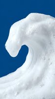 Dramatic white ocean wave crest against deep blue sky background showcasing natural power and motion in seascape photography.