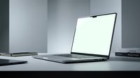 Modern laptop computer with blank white screen on minimalist office desk workspace for business presentations and digital mockups.