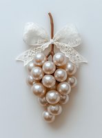 Elegant pearl grape cluster with white lace bow on neutral background for luxury wedding decor and sophisticated craft projects.