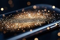 Digital fingerprint scan on smartphone screen with golden bokeh particles and light effects, representing modern biometric security technology.
