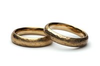 Vintage gold wedding bands with textured and smooth surfaces on white background, symbolizing marriage, commitment and eternal love. Isolated jewelry photography.
