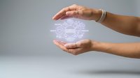 Hands protecting glowing digital brain network symbolizing artificial intelligence, machine learning and cognitive technology innovation.