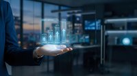 Businessman in blue suit holding glowing holographic city skyline with digital buildings and data analytics interface for urban development and smart city technology concepts.