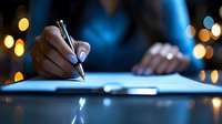 Professional businessperson signing important contract or document with elegant pen in modern office setting with warm bokeh lights creating atmosphere.