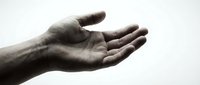 Open male hand gesture reaching out in black and white monochrome style against clean background for emotional communication concepts.