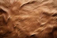 Luxurious brown fur texture with soft, flowing strands creating natural waves and patterns. Close-up macro photography reveals detailed animal coat structure.