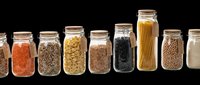 Assorted glass jars with cork lids containing dried foods including lentils, grains, pasta, and legumes. Isolated on transparent background, ready for clipart, print-on-demand, t-shirt design, sublimation, and kitchen-related graphics.