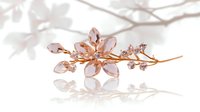 Elegant rose gold floral hair pin with crystal petals and delicate branch design on white background with soft shadow overlay, isolated for accessory styling.