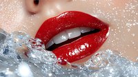 Glossy red lips with water splash effect on pale skin, dramatic close-up with sparkle overlay and frozen motion capturing liquid dynamics against white background.