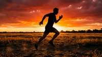 Silhouette of male athlete sprinting across rural field at sunset, arms pumping in dynamic running motion against dramatic orange and red sky. For fitness, sports, and wellness marketing.