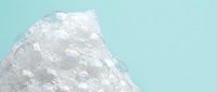 Iridescent crystal formation with holographic rainbow reflections on soft mint background for modern design projects and wellness branding.