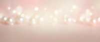 Soft pink bokeh lights background with warm glowing orbs creating dreamy atmosphere for romantic designs, wedding invitations, and feminine branding projects.