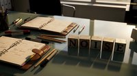 Organized office desk with wooden rubber stamps, documents and pens in natural sunlight for business correspondence and administrative work.
