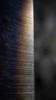 Close-up macro shot of weathered wood grain with natural texture and warm lighting creating depth and shadow for interior design projects.