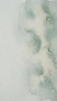Abstract watercolor background with soft green and beige tones creating organic flowing patterns for artistic design projects and creative layouts.