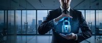 Professional businessman in dark suit protecting glowing blue digital padlock hologram with hands in modern office, representing cybersecurity and data protection.