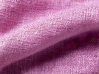 Pink linen fabric with natural texture and weave pattern in macro close up view, showing detailed textile structure and soft wavy folds in pastel color.
