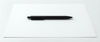 Black ballpoint pen lying on clean white paper sheet, minimalist office supplies setup for writing, business correspondence and professional documentation.