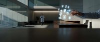 Young male professional in business attire stands in modern office lobby while hand interacts with digital holographic interface displaying technology icons and data visualization.