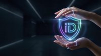 Hands protecting glowing digital identity shield symbol with neon lights representing cybersecurity data protection and privacy technology concept.