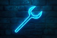 Glowing blue neon wrench sign against dark brick wall background, symbolizing repair service or mechanical workshop.