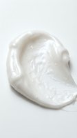 Creamy white moisturizer or skincare product with smooth, luxurious texture displayed on neutral background for cosmetics and beauty applications.