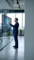 Professional businessman in suit interacting with futuristic holographic display showing digital brain and data analytics in modern glass office environment.